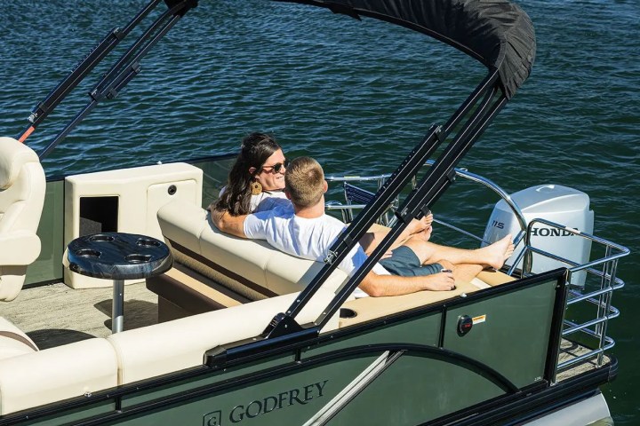 a couple sitting in a boat on a body of water