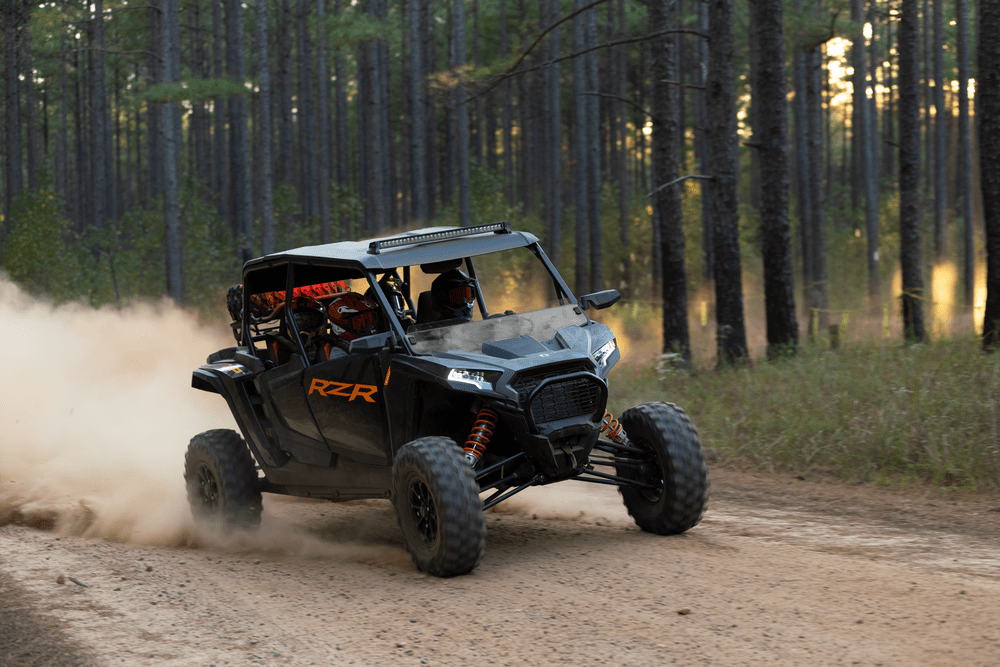 a truck driving down a dirt road