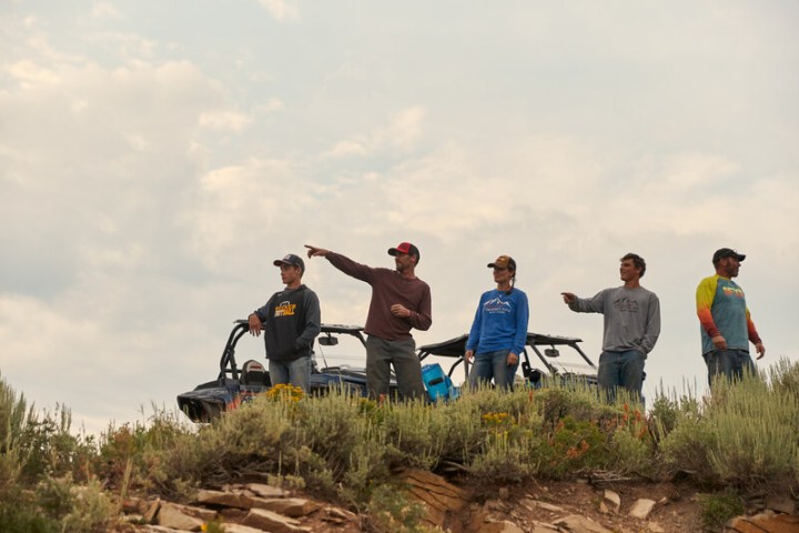 a group of people standing on top of a hill